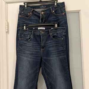 Two pair of slightly washed dark denim jeans:  sit on hip.